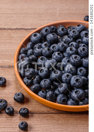 Fresh, ripe, and juicy wild blueberries as an ingredient for vegetarian dishes Fresh, ripe, and juicy wild blueberries as an ingredient for vegetarian dishes 141680201