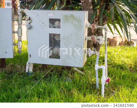 Water meters in the park. Calculating water waste. Utility payment concept. Water meters in the park. Calculating water waste. Utility payment concept. 141681590