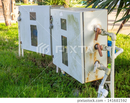 Water meters in the park. Calculating water waste. Utility payment concept Water meters in the park. Calculating water waste. Utility payment concept 141681592