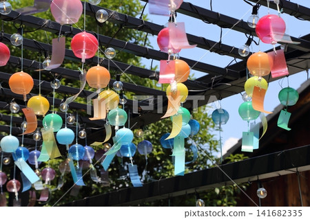 Seven-colored wind chimes ring softly at the Kurokabe Glass Museum. Seven-colored wind chimes ring softly at the Kurokabe Glass Museum. 141682335