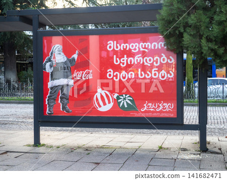 Advertising Coca Cola at a bus stop. Coca Cola advertising in Georgia. New Year's advertising. Carbonated drink. Advertising Coca Cola at a bus stop. Coca Cola advertising in Georgia. New Year's advertising. Carbonated drink. 141682471