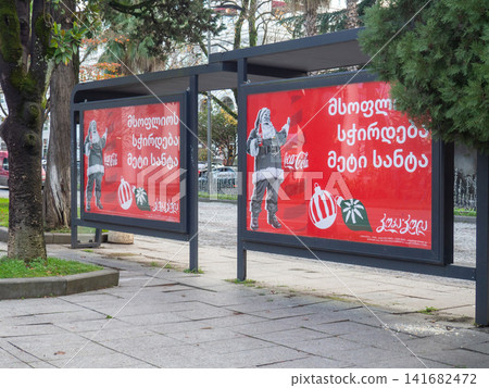 Advertising Coca Cola at a bus stop. Coca Cola advertising in Georgia. New Year's advertising. Carbonated drink. Advertising Coca Cola at a bus stop. Coca Cola advertising in Georgia. New Year's advertising. Carbonated drink. 141682472
