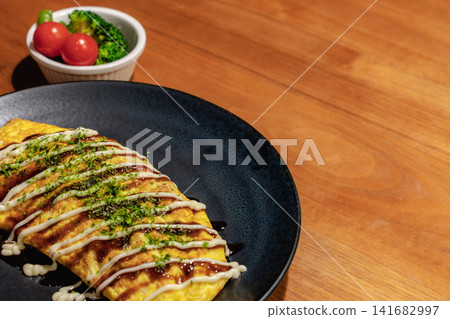 Omelet topped with Japanese-style sauce and dried seaweed flakes Omelet topped with Japanese-style sauce and dried seaweed flakes 141682997