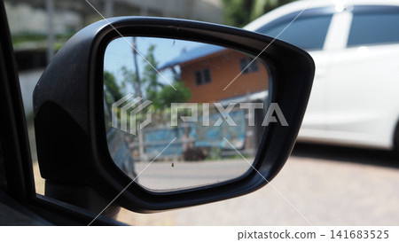 Side mirror, car, reflection, street, house view in vehicle mirror Side mirror, car, reflection, street, house view in vehicle mirror 141683525