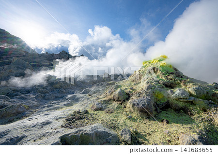 A valley of sulfur with rising plumes of smoke, a spectacular view of the volcanic region. A valley of sulfur with rising plumes of smoke, a spectacular view of the volcanic region. 141683655