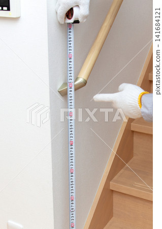 Contractors with handrails and measuring tapes Contractors with handrails and measuring tapes 141684121