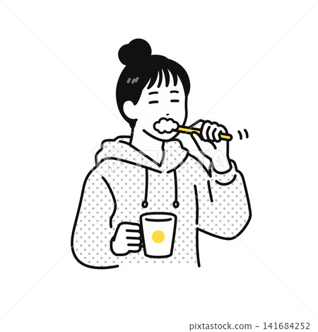 一位頭髮綁起來的年輕女子正在刷牙。 一位頭髮綁起來的年輕女子正在刷牙。 141684252