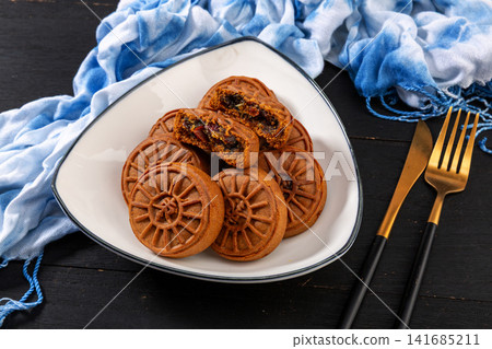 traditional Chinese jujube paste pastry mooncake with red date filling, Mid-Autumn festival dessert isolated,The text in the middle of the dessert reads: "Date". traditional Chinese jujube paste pastry mooncake with red date filling, Mid-Autumn festival dessert isolated,The text in the middle of the dessert reads: "Date". 141685211