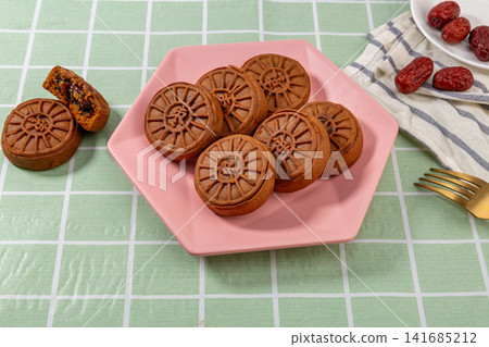 traditional Chinese jujube paste pastry mooncake with red date filling, Mid-Autumn festival dessert isolated,The text in the middle of the dessert reads: "Date". traditional Chinese jujube paste pastry mooncake with red date filling, Mid-Autumn festival dessert isolated,The text in the middle of the dessert reads: "Date". 141685212