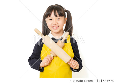 Asian little girl holding rolling pin, playful cooking concept, happy child lifestyle, home activity portrait Asian little girl holding rolling pin, playful cooking concept, happy child lifestyle, home activity portrait 141685670