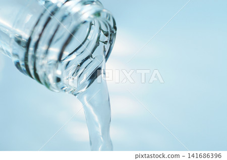 Pour in mineral water from a glass bottle. Pour in mineral water from a glass bottle. 141686396