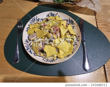 Fresh Mexican style chicken salad with tortilla chips, corn, tomatoes and creamy dressing served on decorative ceramic plate Fresh Mexican style chicken salad with tortilla chips, corn, tomatoes and creamy dressing served on decorative ceramic plate 141686511
