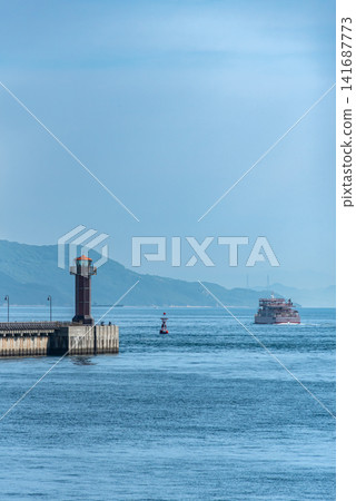 Kagawa Prefecture: Glass lighthouse and a departing ferry Kagawa Prefecture: Glass lighthouse and a departing ferry 141687773