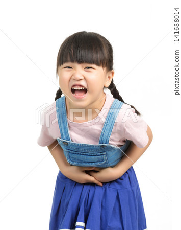 Child having stomach ache holding belly with uncomfortable facial expression Child having stomach ache holding belly with uncomfortable facial expression 141688014