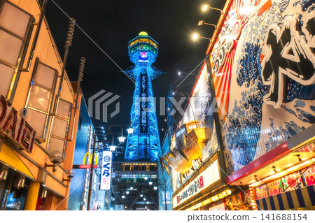 Tsutenkaku tower in Shinsekai Osakas by fancy billboard at night , Japan Tsutenkaku tower in Shinsekai Osakas by fancy billboard at night , Japan 141688154