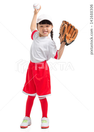 Full length view of a young baseball player raising her gloved hand against a white backdrop. 141688306