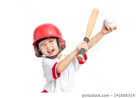 Portrait of a smiling girl wearing a red helmet and holding a bat and baseball on white background. 141688319