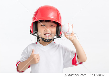 Happy young baseball player giving a thumbs up gesture while holding a ball in studio. Happy young baseball player giving a thumbs up gesture while holding a ball in studio. 141688320
