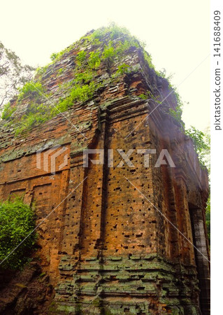 The red brick tower of Prasat Kraham, part of the Koh Ker archaeological site, stands in the forest. The red brick tower of Prasat Kraham, part of the Koh Ker archaeological site, stands in the forest. 141688409