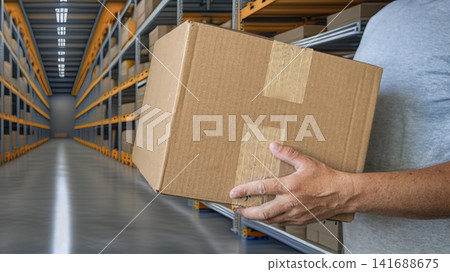 Warehouse Worker Carrying Cardboard Shipping Box Warehouse Worker Carrying Cardboard Shipping Box 141688675