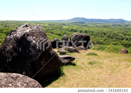 Oshitoishi Hill in Aso, Kumamoto Prefecture: A landscape of green grasslands and megalithic ruins of ancient sites. Oshitoishi Hill in Aso, Kumamoto Prefecture: A landscape of green grasslands and megalithic ruins of ancient sites. 141689183