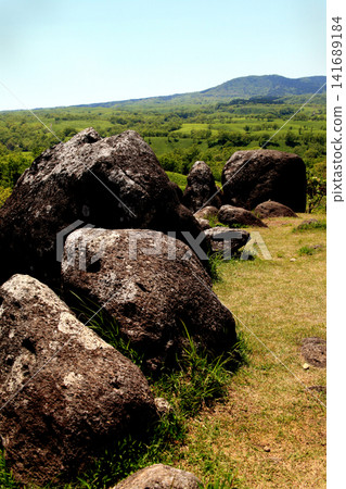 Oshitoishi Hill in Aso, Kumamoto Prefecture: A landscape of green grasslands and megalithic ruins of ancient sites. Oshitoishi Hill in Aso, Kumamoto Prefecture: A landscape of green grasslands and megalithic ruins of ancient sites. 141689184
