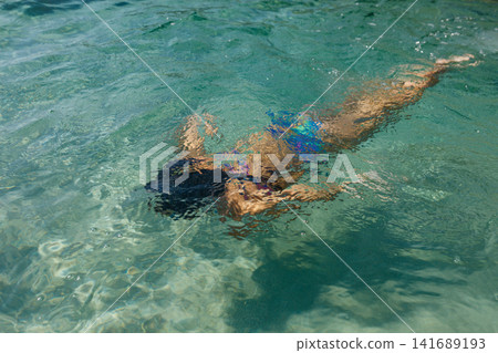 Child Swimming Underwater in Crystal Clear Tropical Sea Child Swimming Underwater in Crystal Clear Tropical Sea 141689193