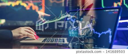 Stock market investment and cryptocurrency trading concept. Businesswoman analyzing financial candlestick charts and graphs overlaid on a laptop. Stock market investment and cryptocurrency trading concept. Businesswoman analyzing financial candlestick charts and graphs overlaid on a laptop. 141689503