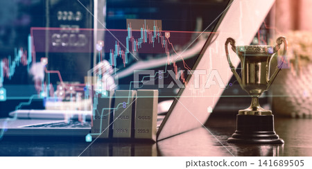 Digital commodity trading and financial success concept. Gold bars and winner trophy with double exposure of stock market candlestick charts. Digital commodity trading and financial success concept. Gold bars and winner trophy with double exposure of stock market candlestick charts. 141689505