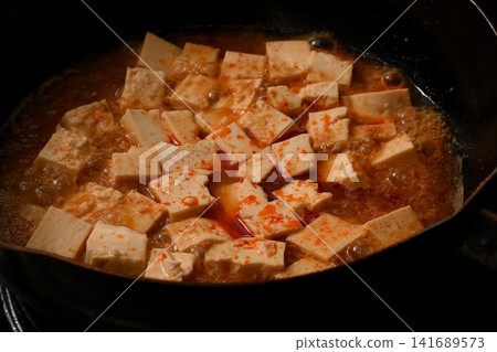 Mapo tofu being cooked Mapo tofu being cooked 141689573