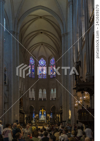 Interior and stained glass windows of Notre Dame Cathedral in Paris, France Interior and stained glass windows of Notre Dame Cathedral in Paris, France 141689879