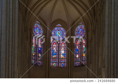 Interior and stained glass windows of Notre Dame Cathedral in Paris, France Interior and stained glass windows of Notre Dame Cathedral in Paris, France 141689880