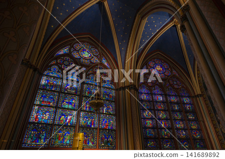 Interior and stained glass windows of Notre Dame Cathedral in Paris, France Interior and stained glass windows of Notre Dame Cathedral in Paris, France 141689892
