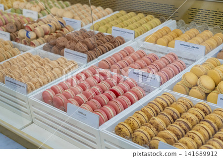 Colorful macarons beautifully arranged in the display case of a Western-style confectionery shop. Colorful macarons beautifully arranged in the display case of a Western-style confectionery shop. 141689912