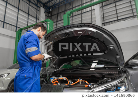 Professional EV Car Service, Male workers Electricity Vehicle Fix Maintenance in EV Garage workshop. Professional EV Car Service, Male workers Electricity Vehicle Fix Maintenance in EV Garage workshop. 141690866