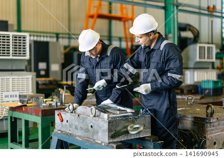 Engineer worker team service injection mold, Professional men work in die casting plant mold service Engineer worker team service injection mold, Professional men work in die casting plant mold service 141690945