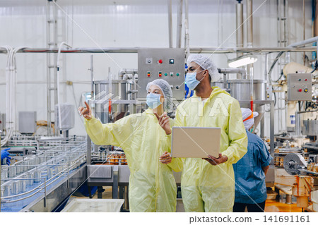 Food factory workers team product inspection, Quality control in food industry cannery conveyor belt Food factory workers team product inspection, Quality control in food industry cannery conveyor belt 141691161