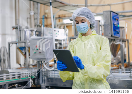 Food industry people worker, Quality control staff inspecting cannery food product in production line conveyor belt in food factory plant. 141691166