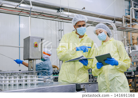 Food industry people worker, Quality control staff inspecting cannery food product in production line conveyor belt in food factory plant. 141691168