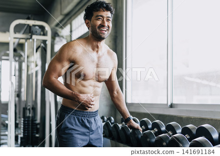 Happy laughing healthy man muscular athlete people enjoy wellness lifestyle live strong workout gym. Happy laughing healthy man muscular athlete people enjoy wellness lifestyle live strong workout gym. 141691184