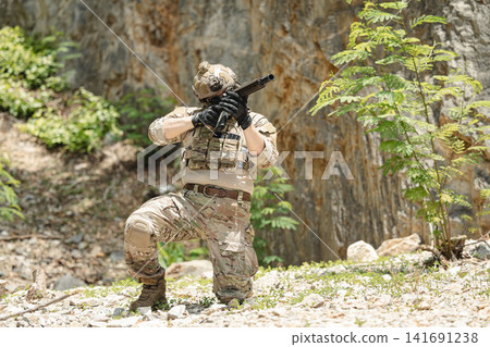 US Special forces soldiers engaged in combat operation, tactical military team in action US Special forces soldiers engaged in combat operation, tactical military team in action 141691238