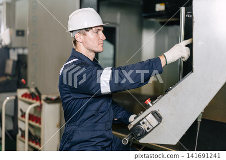 Professional engineer Caucasian male worker control operate CNC Machine in industry metal factory Professional engineer Caucasian male worker control operate CNC Machine in industry metal factory 141691241
