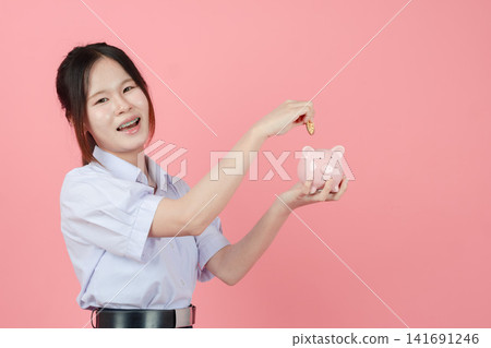 Portrait Asian student in uniform, Woman teen girl cute pretty cheerful happy smile with piggy bank 141691246