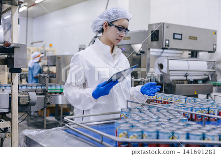 Food industry people worker, Quality control staff inspecting cannery food product in production line conveyor belt in food factory plant. Food industry people worker, Quality control staff inspecting cannery food product in production line conveyor belt in food factory plant. 141691281