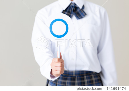 A middle school girl in uniform holding a round plate - gray background A middle school girl in uniform holding a round plate - gray background 141691474