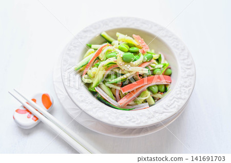 Zucchini, edamame, and crab stick salad with ponzu sauce Zucchini, edamame, and crab stick salad with ponzu sauce 141691703