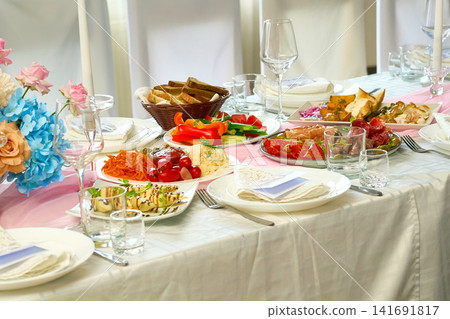 Set festive table with various dishes awaiting guests Set festive table with various dishes awaiting guests 141691817
