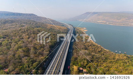 Drone shot aerial view landscape of the M6 motorway Expressway Nakhon Ratchasima Province - Bang Pa-in. Lam Ta Khong River and Mountain. Drone shot of scenic landscape rural place traffic. Nakhon Drone shot aerial view landscape of the M6 motorway Expressway Nakhon Ratchasima Province - Bang Pa-in. Lam Ta Khong River and Mountain. Drone shot of scenic landscape rural place traffic. Nakhon 141691926