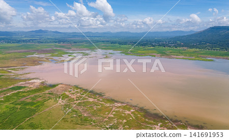 A wide aerial shot of Lam Takhong reservoir surrounded by hills and greenery in Nakhon Ratchasima. The scenic water source blends nature, infrastructure, and regional beauty A wide aerial shot of Lam Takhong reservoir surrounded by hills and greenery in Nakhon Ratchasima. The scenic water source blends nature, infrastructure, and regional beauty 141691953