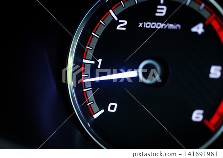 Close-up of a diesel truck's dashboard and tachometer. It represents the power and durability of a work vehicle, with a clear focus on the round engine meters. Close-up of a diesel truck's dashboard and tachometer. It represents the power and durability of a work vehicle, with a clear focus on the round engine meters. 141691961